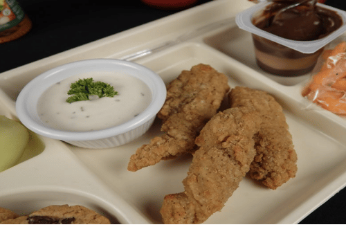 Beige lunch tray with chicken tenders and dipping sauce
