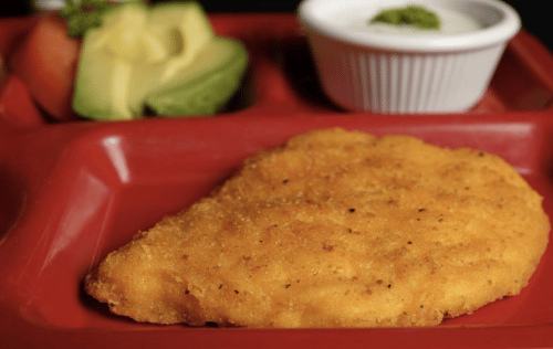 Chicken patty on red lunch serving tray